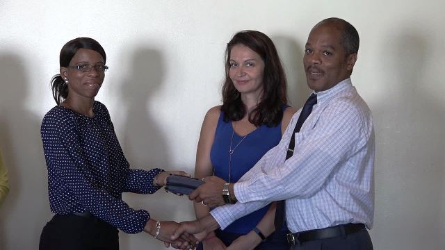 Hospital Administrator at the Alexandra Hospital Gary Pemberton hands over equipment for use at the Paediatric Ward to Paediatrician Dr. Cloe Smithen. Carolyn Chisholm, Treasurer of the Paediatric Assistance League of St. Kitts and Nevis (middle) looks on moments after she handed over the gift to Pemberton at the hospital’s conference room on October 18, 2016